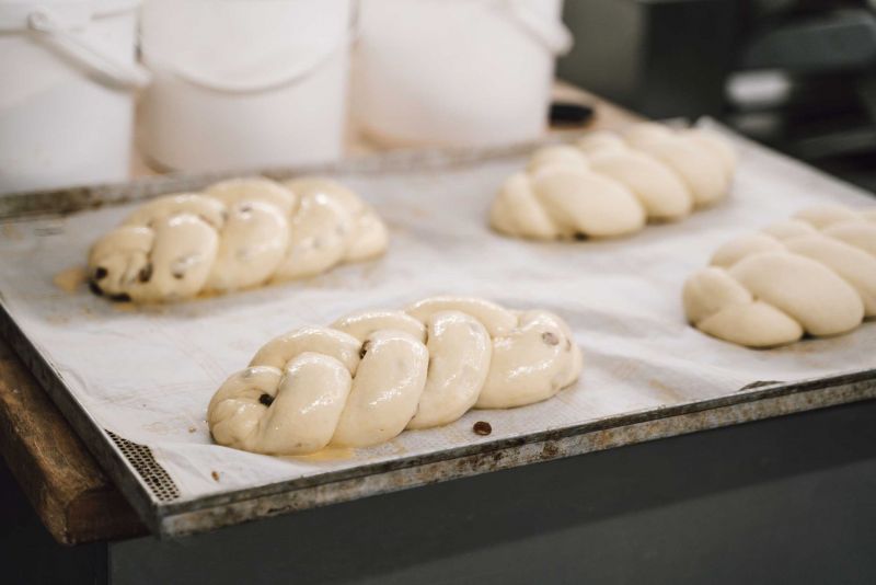 Braided yeast loaves on a baking tray